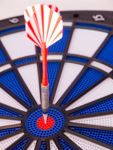 blue dartboard with darts 