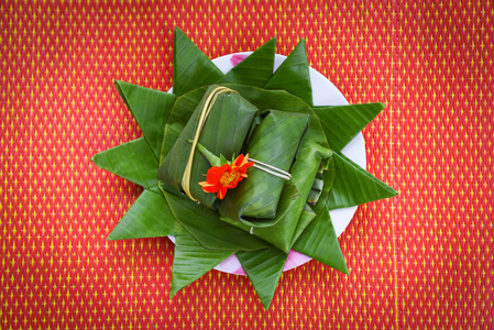 food and dessert thai wrapped in banana leaf on plate 