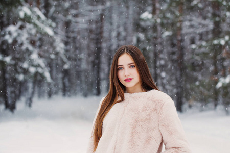 beautiful girl in winter forest 