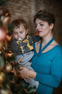 Family New Year. Portrait of mom with baby at the New Year tree 