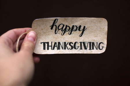 The inscription Happy Thanksgiving in the hand