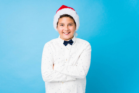 Elegant kid wearing a santa hat on a christmas day