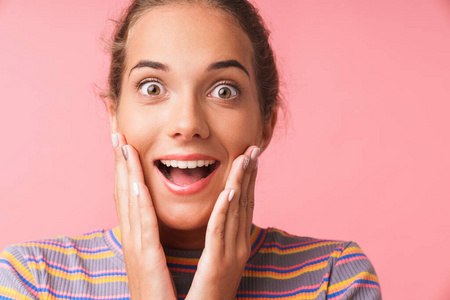 Image closeup of amazed young woman dressed in colorful clothes 