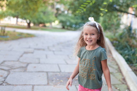 Emotional portrait of a positive and cheerful little girl with l