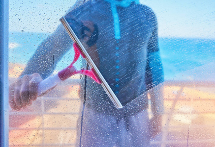 男子正在用雨刷擦玻璃窗图片