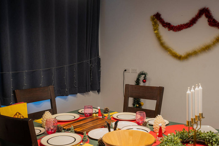 Empty dining room is decorated with Christmas tree and gift pres