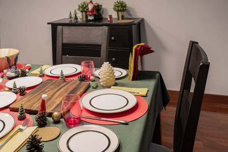 Empty dining room is decorated with Christmas tree and gift pres