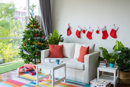 Empty living room is decorated with Christmas tree and gift pres