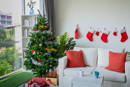 Empty living room is decorated with Christmas tree and gift pres