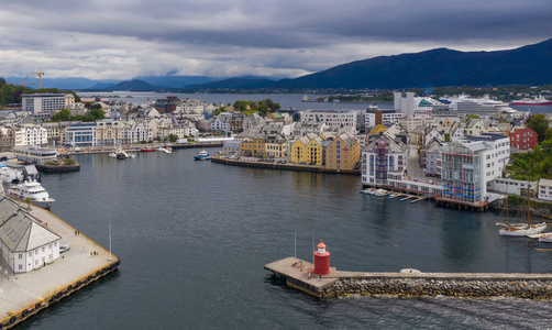 Alesund, Norway  July, 2019 Pier leading to the red lighthouse