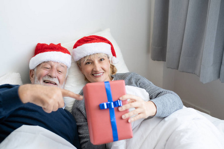 senior elderly caucasian old man and woman give gift or present 