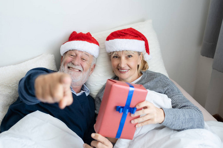 senior elderly caucasian old man and woman give gift or present 