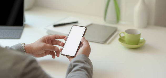 Closeup view of professional businessman holding blank screen s