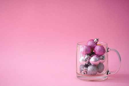 Christmas composition. Pink and gray christmas balls in a transp