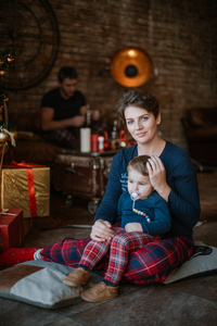 Family New Year. Portrait of mom with baby at the New Year tree 