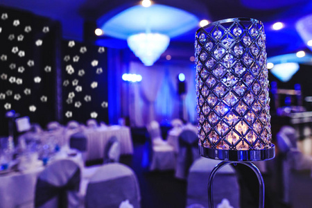 Candle light dinner in purple events room. Crystal glass lights 