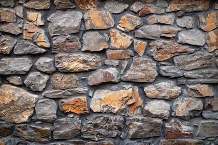 Stone wall. Wall of hewn wild stone. Stone background. 