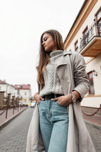 Elegant young modern woman in stylish autumnspring clothes stan