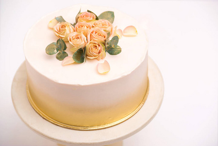 Elegant wedding cake with beautiful roses flowers on white table