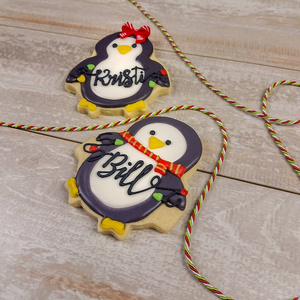 Side view of personalized christmas penguins as decorated sugar 