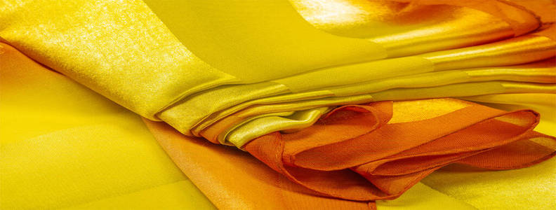 Texture, background, yellow silk striped fabric with a metallic 