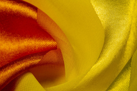 Texture, background, yellow silk striped fabric with a metallic 