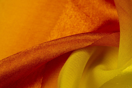 Texture, background, yellow silk striped fabric with a metallic 