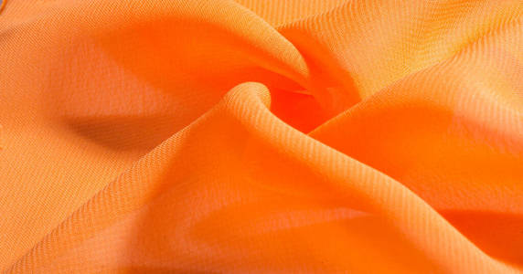 背景图案质感，橘红色丝织物有着灿烂的色彩