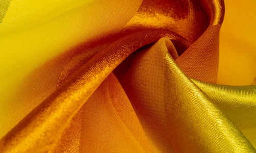 Texture, background, yellow silk striped fabric with a metallic 