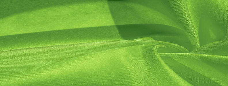 Texture, background, pattern, silk green fabric. Crepe satin on 