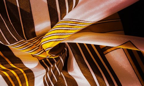 Texture, background, silk fabric with a yellow striped pattern. 