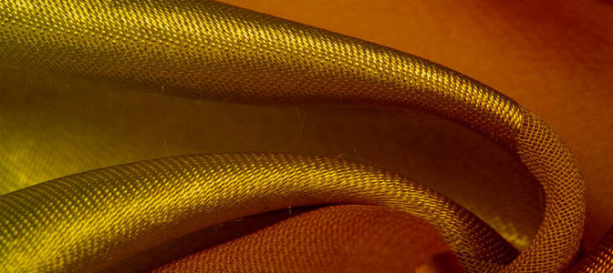 Texture, background, yellow silk striped fabric with a metallic 