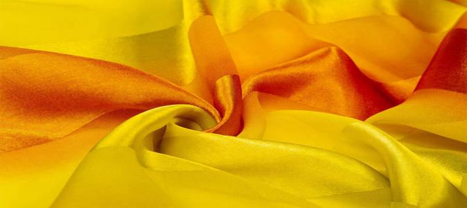 Texture, background, yellow silk striped fabric with a metallic 