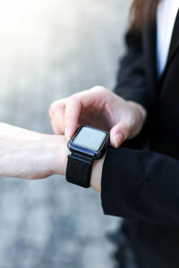  Beautiful Young businesswoman   looking at her smart watch