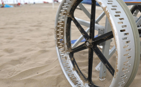 wheel of a special wheelchair to move easily in the sand of the 