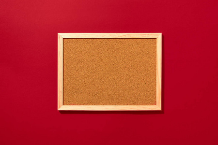 Empty coark board on red background