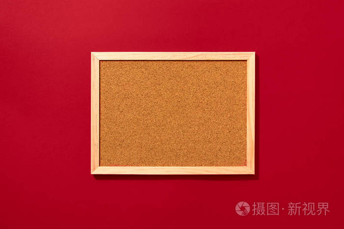 Empty coark board on red background