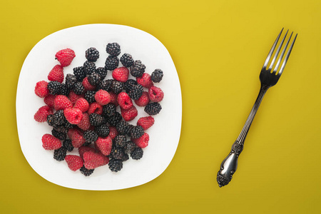  blackberry and raspberry on a white plate. blackberry and raspb