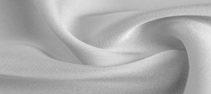 background texture, pattern. White silk fabric. It has a smooth 