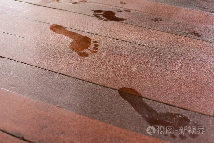 满是灰尘的木地板上的脚印