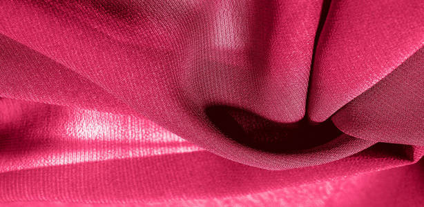 Background texture of silk fabric. This is a natural red scarf, 