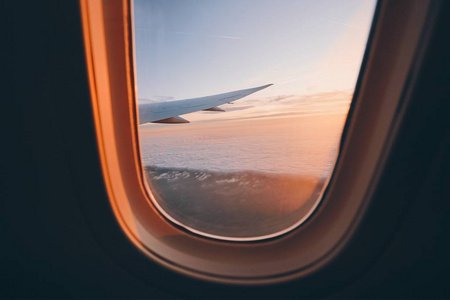 Beautiful sunset look through airplane window 