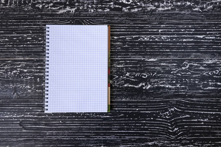 The notebook on a white black table with a copy space. 