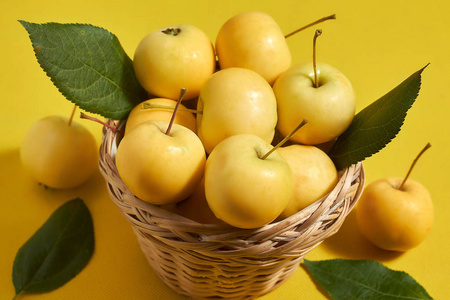 黄苹果在黄底篮子里放维生素，营养适当。