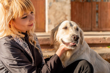 快乐的高加索女人和她的拉布拉多猎犬在公园里享受时光