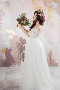 Elegant brunette girl bride with flowers. Beautiful young bride 