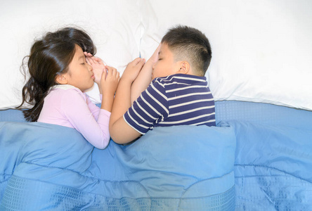 Two children sleep on bed togather, 