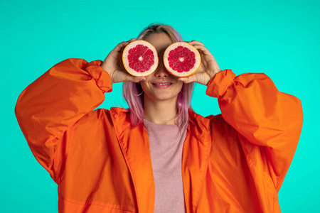 Joyful young hipster with dyed pink hairstyle with two half of j