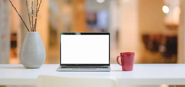 Closeup view of comfortable workplace with mock up laptop compu