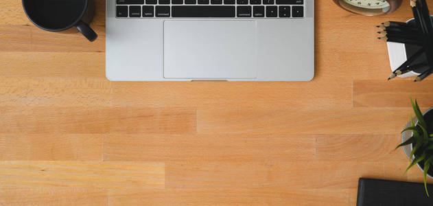 Overhead shot of comfortable workspace with laptop computer, off